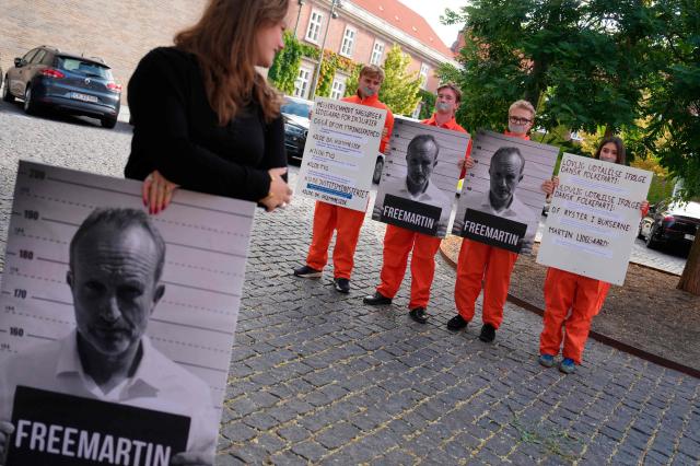 Young supporters of Denmark's The Social Liberal Party hold up posters depicting their political leader Martin Lidegaard as he arrives at the court in Frederiksberg, Denmark, on August 18, 2026 for a civil case with the leader of another political party. The chariman of The Danish People's Party Morten Messerschmidt is suing the political leader of The Social Liberal Party Martin Lidegaard after a statement from Lidegaard that The Danish People Party's policy advocated for internment camps based on skin color. (Photo by Liselotte Sabroe / Ritzau Scanpix / AFP) / Denmark OUT