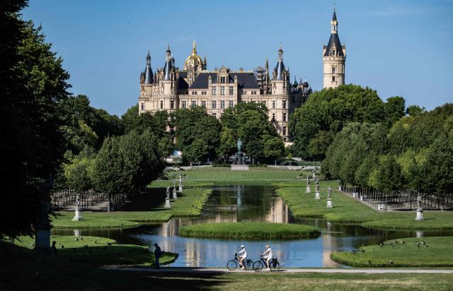 View of the Schwerin Palace taken on August 14, in Schwerin, northern Germany. The palace, built in the 19th Century to replace an earlier castle, houses the state parliament of the state of Mecklenburg-West Pomerania since the 1990s. (Photo by John MACDOUGALL / AFP)