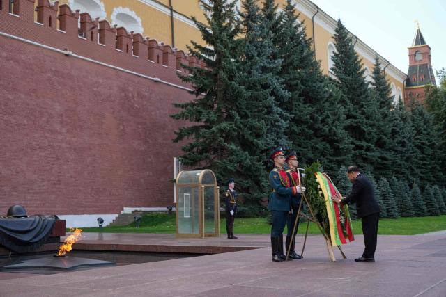 Myanmar's President Min Aung Hlaing adjusts ribbons as he attends a wreath-laying ceremony at the Tomb of the Unknown Soldier near the Kremlin wall in Moscow on August 18, 2026. (Photo by Pavel Bednyakov / POOL / AFP)