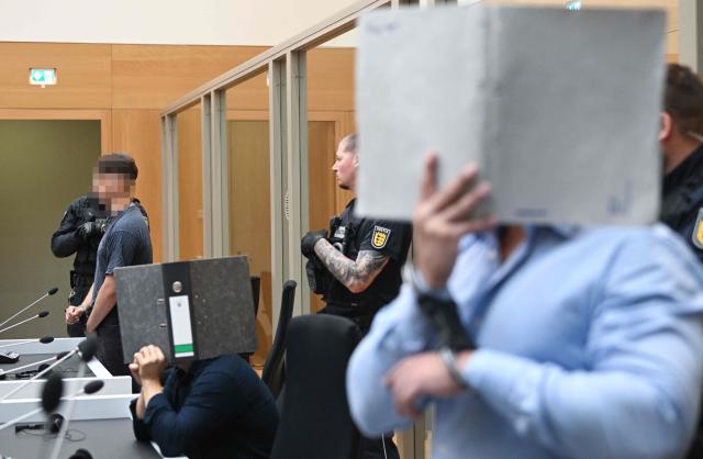 Three Ukrainian defendants, who are accused for plotting to send exploding parcels from Germany to Ukraine on the orders of a Russian intelligence service, wait for the verdict of their trial in the courtroom of the higher regional court in Stuttgart-Stammheim, southern Germany on on August 18, 2026. (Photo by THOMAS KIENZLE / AFP)