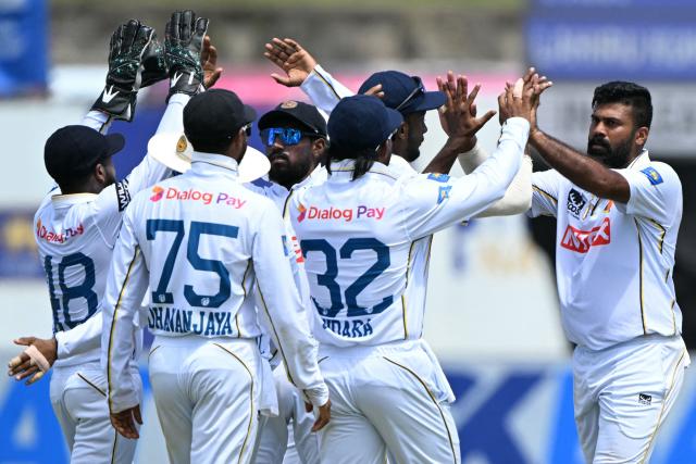 Sri Lanka's Lahiru Kumara (R) celebrates with teammates after taking the wicket of India's Rishabh Pant during the fourth day of the first Test cricket match between Sri Lanka and India at the Galle International Stadium in Galle on August 18, 2026. (Photo by Ishara S. KODIKARA / AFP)