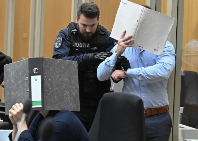 Two of totally three Ukrainian defendants, who are accused for plotting to send exploding parcels from Germany to Ukraine on the orders of a Russian intelligence service, are seen in the courtroom prior to the verdict of their trial at the higher regional court in Stuttgart-Stammheim, southern Germany on on August 18, 2026. (Photo by THOMAS KIENZLE / AFP)