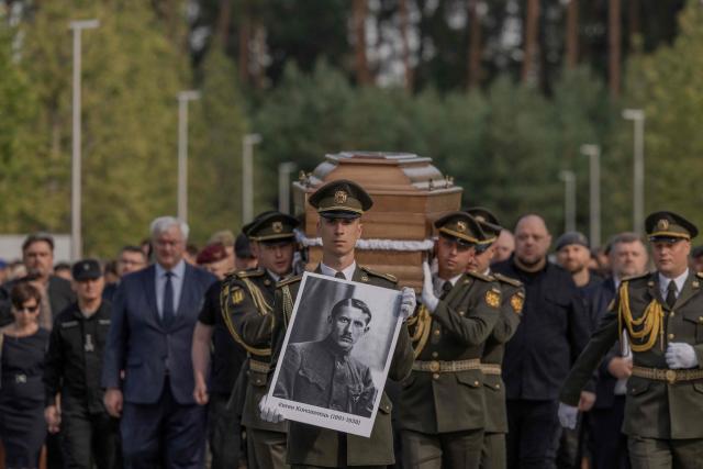 Servicemen of the Ukrainian Honour Guard carry the coffin bearing the repatriated remains of Yevhen Konovalets, leader of the Organisation of Ukrainian Nationalists (OUN), who was killed by a Soviet agent in 1938, during his reburial ceremony at the National Military Memorial Cemetery near Kyiv on August 18, 2026, amid the Russian invasion of Ukraine. (Photo by Roman PILIPEY / AFP)