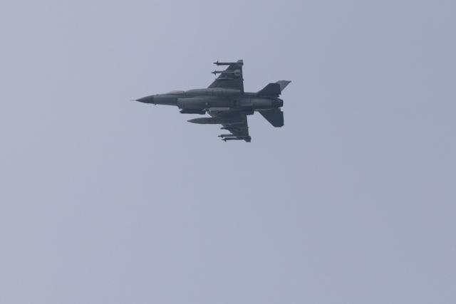 An F-16 fighter jet flies in the sky over Kyiv on August 18, 2026, amid the Russian invasion of Ukraine. (Photo by Roman PILIPEY / AFP)