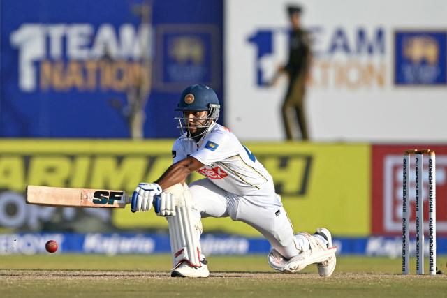 Sri Lanka's Sonal Dinusha plays a shot during the fourth day of the first Test cricket match between Sri Lanka and India at the Galle International Stadium in Galle on August 18, 2026. (Photo by Ishara S. KODIKARA / AFP)
