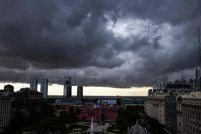 (FILES) Storm clouds cover the skyline of downtown of Buenos Aires, on February 7, 2020. Household arrears in Argentina have tripled in twelve months and reached in 2026 their highest level in 20 years during Javier Milei’s government. The main problem is stagnant incomes and soaring living costs, particularly due to utility bills, which have far outstripped inflation since the ultra-liberal president came to power in December 2023. (Photo by RONALDO SCHEMIDT / AFP)
