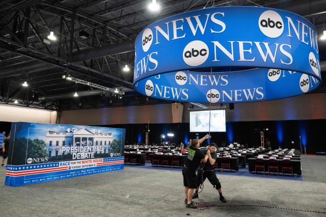 (FILES) Workers complete preparations on the media filing center and spin room for the ABC News Presidential Debate between Democratic candidate Vice President Kamala Harris and Republican candidate former US President Donald Trump, in Philadelphia, Pennsylvania, September 9, 2024. The Disney-owned ABC television network sued the Federal Communications Commission (FCC) on August 18, 2026, over a potential threat to its broadcast licenses. The suit filed in a federal court in Washington accuses the Trump administration, through the FCC, of waging a "retaliatory campaign against ABC for a single reason: it disapproves of what ABC broadcasts." (Photo by SAUL LOEB / AFP)