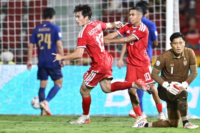 Singapore’s Harhys Stewart (C) celebrates with a teammate after scoring a goal during the second leg of the 2026 ASEAN Championship football semi-final match between Thailand and Singapore at Rajamangala National Stadium in Bangkok on August 18, 2026. (Photo by ANTHONY WALLACE / AFP)