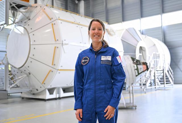 (FILES) ESA astronaut candidate Sophie Adenot from France poses after a press conference of the European Space Agency (ESA) 2022 class of astronauts at the European Astronaut Centre (EAC) in Cologne, western Germany on May 3, 2023. Sophie Adenot became the first French female astronaut to venture outside the International Space Station for a spacewalk on August 18, 2026, accompanied by American astronaut Anil Menon. President Emmanuel Macron hailed Sophie Adenot's spacewalk, describing the event as a source of "French pride" and seeing the astronaut as "the face of all possibilities." (Photo by Ina FASSBENDER / AFP)