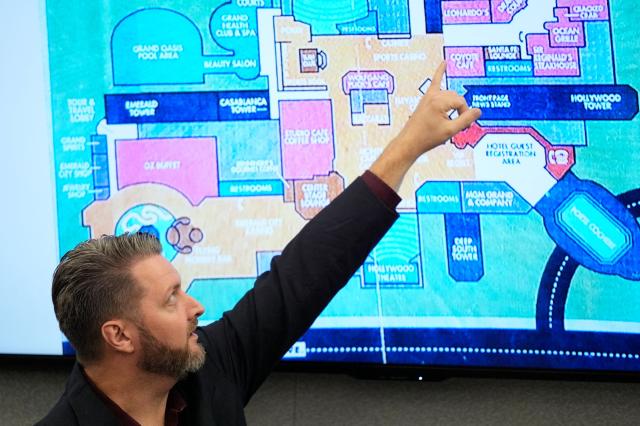 Michael Ingram, investigator for MGM Resorts, points to a map of the MGM Grand casino as he testifies during the murder trial of Duane Davis, related to the 1996 killing of rapper Tupac Shakur, at the Clark County District Court at the Regional Justice Center in Las Vegas, Nevada, on August 18, 2026. The trial of the former gang leader accused of orchestrating the murder of rapper Tupac Shakur began on August 10, 30 years after one of America's most high-profile unresolved killings. The proceedings, expected to last a month, will likely not make clear who fired the shots that killed the California hip-hop legend on the night of September 7, 1996, while he was in Las Vegas to see a Mike Tyson boxing match. (Photo by John Locher / POOL / AFP)