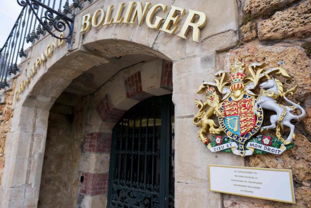This photograph shows a “Champagne Bollinger” sign and the coat of arms of the British Crown at the Bollinger Champagne House’s vineyard in Ay, northeastern France, on August 18, 2026. (Photo by Jean-Christophe VERHAEGEN / AFP)
