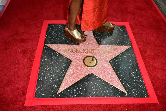 Beninese musician and actress Angelique Kidjo stands on her newly unveiled star during her Hollywood Walk of Fame star ceremony in the Hollywood neighborhood of Los Angeles on August 18, 2026. (Photo by Frederic J. Brown / AFP)