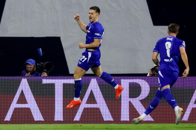Dinamo’s Croatian forward Mateo Lisica #21 (L) celebrates after scoring his team's first goal during the UEFA Championship 1st leg Play-off football match between GNK Dinamo Zagreb and Viking FC at stadium Maksimir in Zagreb, Croatia on August 18, 2026. (Photo by MARKO PERKOV / AFP)