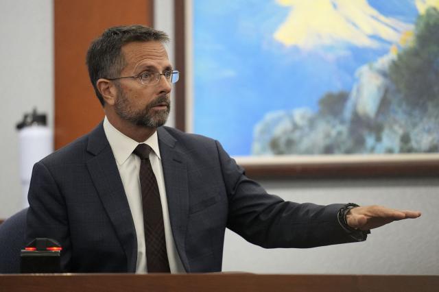 Dean O'Kelley, a Las Vegas police officer who was at the scene of shooting, testifies during the murder trial of Duane Davis, related to the 1996 killing of rapper Tupac Shakur, at the Clark County District Court at the Regional Justice Center in Las Vegas, Nevada, on August 18, 2026. The trial of the former gang leader accused of orchestrating the murder of rapper Tupac Shakur began on August 10, 30 years after one of America's most high-profile unresolved killings. The proceedings, expected to last a month, will likely not make clear who fired the shots that killed the California hip-hop legend on the night of September 7, 1996, while he was in Las Vegas to see a Mike Tyson boxing match. (Photo by John Locher / POOL / AFP)