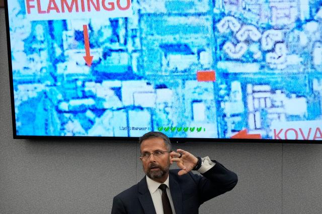 Dean O'Kelley, a Las Vegas police officer at the scene of shooting, testifies in front of a map during the murder trial of Duane Davis related to the 1996 killing of rapper Tupac Shakur, at Clark County District Court Regional Justice Center in Las Vegas, Nevada, on August 18, 2026. The trial of the former gang leader accused of orchestrating the murder of rapper Tupac Shakur began on August 10, 30 years after one of America's most high-profile unresolved killings. The proceedings, expected to last a month, will likely not make clear who fired the shots that killed the California hip-hop legend on the night of September 7, 1996, while he was in Las Vegas to see a Mike Tyson boxing match. (Photo by John Locher / POOL / AFP)