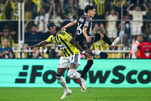 Fenerbahce's British midfielder #03 Archie Brown (L) and Lyon's French forward #26 Kail Boudache fight for the ball during the UEFA Champions League qualifying playoff - first leg football match between Fenerbahce SK and Olympique Lyonnais (OL) at the Sukru Saracoglu Stadium in Istanbul on August 18, 2026. (Photo by YASIN AKGUL / AFP)
