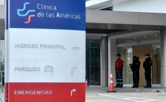 Bolivian police officers stand guard at the entrance to the Clinica de Las Americas, where Bolivian lawyer Nadia Beller --partner of Fernando Cerimedo, personal adviser to the president of Bolivia, Rodrigo Paz-- was hospitalized on the eve after receiving several gunshot wounds, in Santa Cruz, Bolivia, on August 18, 2026. Bolivian police on August 18, 20026 arrested Fernando Cerimedo, an Argentine political consultant who has also worked on the presidential campaigns of other Latin American right-wingers, from Argentina's Javier Milei to former Brazilian leader Jair Bolsonaro, over the shooting of Beller, with whom he has been linked romantically.

. (Photo by RODRIGO URZAGASTI / AFP)