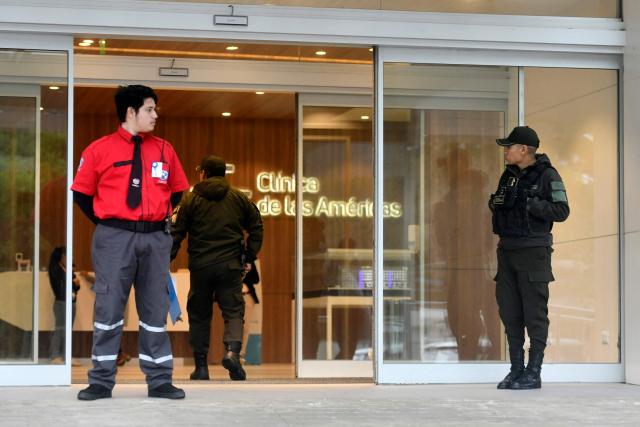 Bolivian police officers stand guard at the entrance to the Clinica de Las Americas, where Bolivian lawyer Nadia Beller --partner of Fernando Cerimedo, personal adviser to the president of Bolivia, Rodrigo Paz-- was hospitalized on the eve after receiving several gunshot wounds, in Santa Cruz, Bolivia, on August 18, 2026. Bolivian police on August 18, 20026 arrested Fernando Cerimedo, an Argentine political consultant, who has also worked on the presidential campaigns of other Latin American right-wingers, from Argentina's Javier Milei to former Brazilian leader Jair Bolsonaro, over the shooting of Beller, with whom he has been linked romantically.

. (Photo by Rodrigo URZAGASTI / AFP)
