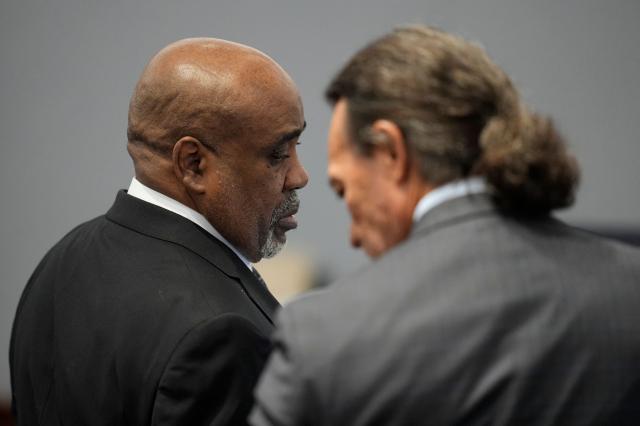 Duane Davis (L) and his defense attorney Michael Sanft stand together during Davis murder trial related to the 1996 killing of rapper Tupac Shakur, at Clark County District Court Regional Justice Center in Las Vegas, Nevada, on August 18, 2026. The trial of the former gang leader accused of orchestrating the murder of rapper Tupac Shakur began on August 10, 30 years after one of America's most high-profile unresolved killings. The proceedings, expected to last a month, will likely not make clear who fired the shots that killed the California hip-hop legend on the night of September 7, 1996, while he was in Las Vegas to see a Mike Tyson boxing match. (Photo by John Locher / POOL / AFP)
