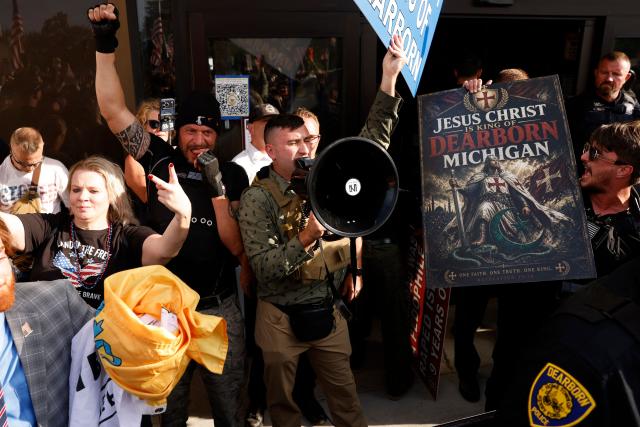 Far-right US activist Jake Lang (C) speaks into a megaphone during an anti-Muslim demonstration he organized called the "Christian Crusade March" in Dearborn, Michigan, on August 18, 2026. (Photo by JEFF KOWALSKY / AFP)