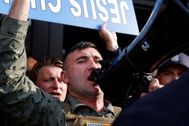 Far-right US activist Jake Lang speaks into a megaphone during an anti-Muslim demonstration he organized called the "Christian Crusade March" in Dearborn, Michigan, on August 18, 2026. (Photo by JEFF KOWALSKY / AFP)