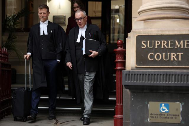 Brendan Kissane (R), Victoria's Director of Public Prosecutions, leaves the Supreme Court of Victoria in Melbourne on August 19, 2026. Australian toxic mushroom killer Erin Patterson's bid to overturn her conviction in a triple-murder case kicked off on August 19, 2026 at a court in Melbourne, according to an official livestream of the proceedings. (Photo by Martin KEEP / AFP)