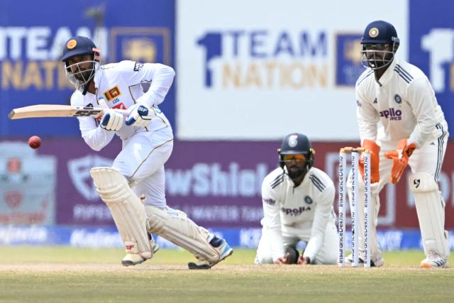 Sri Lanka's captain Dhananjaya de Silva (L) plays a shot during the fifth day of the first Test cricket match between Sri Lanka and India at the Galle International Stadium in Galle on August 19, 2026. (Photo by Ishara S. KODIKARA / AFP)