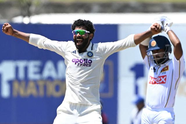 India's Ravindra Jadeja (L) celebrates after taking the wicket of Sri Lanka's captain Dhananjaya de Silva during the fifth day of the first Test cricket match between Sri Lanka and India at the Galle International Stadium in Galle on August 19, 2026. (Photo by Ishara S. KODIKARA / AFP)