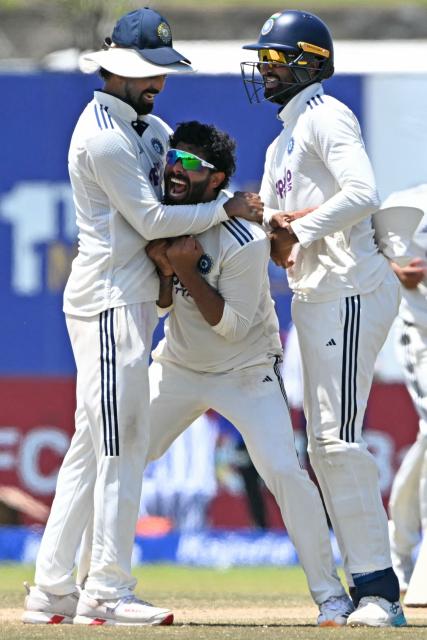India's Ravindra Jadeja (C) celebrates with teammates after taking the wicket of Sri Lanka's captain Dhananjaya de Silva during the fifth day of the first Test cricket match between Sri Lanka and India at the Galle International Stadium in Galle on August 19, 2026. (Photo by Ishara S. KODIKARA / AFP)