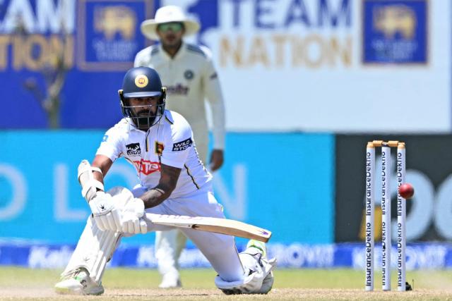 Sri Lanka's Niroshan Dickwella (L) plays a shot as India's captain Shubman Gill looks on during the fifth day of the first Test cricket match between Sri Lanka and India at the Galle International Stadium in Galle on August 19, 2026. (Photo by Ishara S. KODIKARA / AFP)