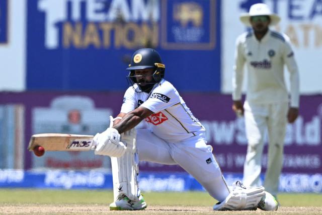Sri Lanka's Niroshan Dickwella (L) plays a shot as India's captain Shubman Gill looks on during the fifth day of the first Test cricket match between Sri Lanka and India at the Galle International Stadium in Galle on August 19, 2026. (Photo by Ishara S. KODIKARA / AFP)