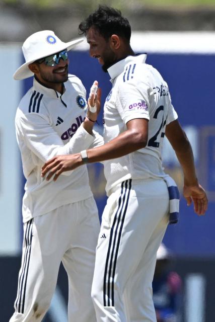 India's Prasidh Krishna (R) celebrates with captain Shubman Gill (L) after taking the wicket of Sri Lanka's Niroshan Dickwella during the fifth day of the first Test cricket match between Sri Lanka and India at the Galle International Stadium in Galle on August 19, 2026. (Photo by Ishara S. KODIKARA / AFP)