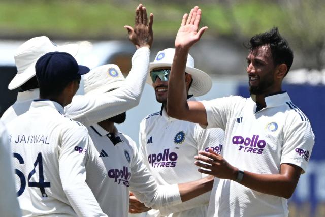 India's Prasidh Krishna (R) celebrates with teammates after taking the wicket of Sri Lanka's Niroshan Dickwella during the fifth day of the first Test cricket match between Sri Lanka and India at the Galle International Stadium in Galle on August 19, 2026. (Photo by Ishara S. KODIKARA / AFP)