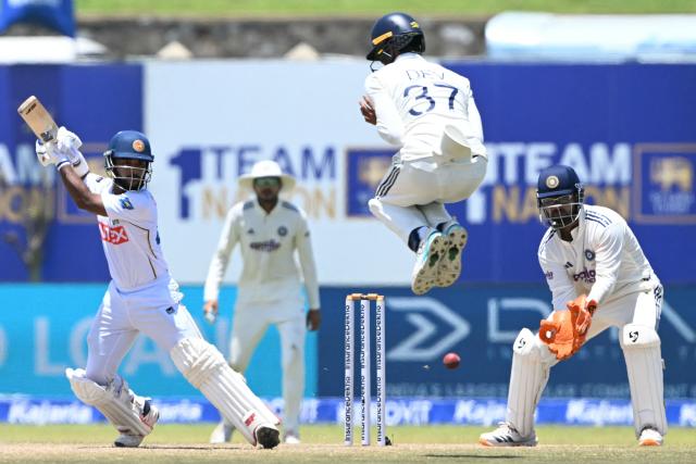 Sri Lanka's Sonal Dinusha (L) plays a shot during the fifth day of the first Test cricket match between Sri Lanka and India at the Galle International Stadium in Galle on August 19, 2026. (Photo by Ishara S. KODIKARA / AFP)