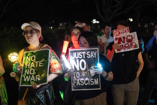 Protesters hold up signs as they listen to speakers during a rally against the current government across the street from the National Diet in Tokyo on August 19, 2026. (Photo by ANDREW CABALLERO-REYNOLDS / AFP)