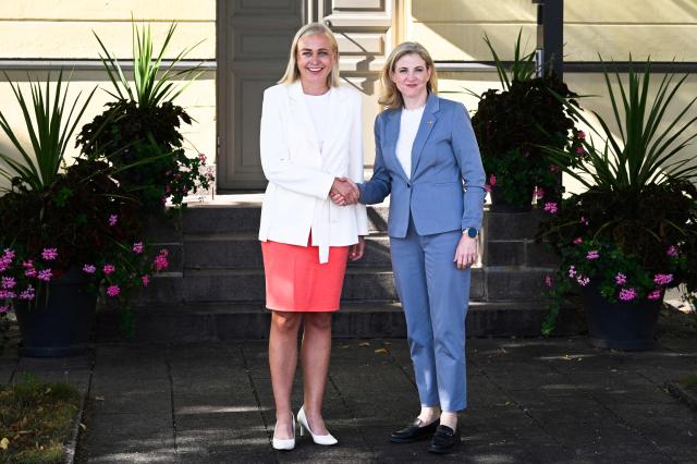 Finnish Foreign Minister Elina Valtonen (L) and Austria's Foreign Minister Beate Meinl-Reisinger shake hands as they meet in Helsinki, Finland, on August 19, 2026. (Photo by Markku Ulander / Lehtikuva / AFP) / Finland OUT