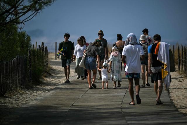 Visitors flock to the Grand Crohot beach in Lege-Cap-Ferret along the Atlantic Ocean, south-western France on August 19, 2026, two days after it reopened following its closure in the wake of the wildfire which swept through the Gironde region in late July. (Photo by Christophe ARCHAMBAULT / AFP)