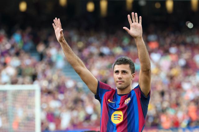Barcelona's new player, Spanish international Rodrigo Hernandez "Rodri" gestures to supporters during the 61st Joan Gamper Trophy football match between FC Barcelona and Al Ahly FC at the Camp Nou Stadium in Barcelona on August 19, 2026. (Photo by Lluis GENE / AFP)
