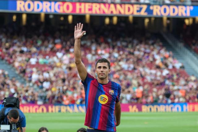 Spanish international footballer Rodrigo Hernandez "Rodri" gestures to supporters during the 61st Joan Gamper Trophy football match between FC Barcelona and Al Ahly FC at the Camp Nou Stadium in Barcelona on August 19, 2026. (Photo by Lluis GENE / AFP)