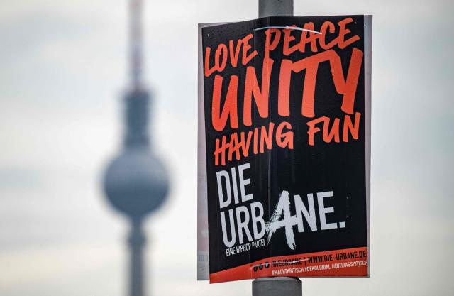 An election campaign placard for the HipHop party "Die Urbane" (The Urbans) hangs on a lamp post in front of the TV Tower in Berlin on August 19, 2026. Berlin goes to the polls on September 20, 2026. Founded in Berlin in February 2017 Die Urbane describes itself as anti-colonial anti-racist and critical of power. (Photo by John MACDOUGALL / AFP)