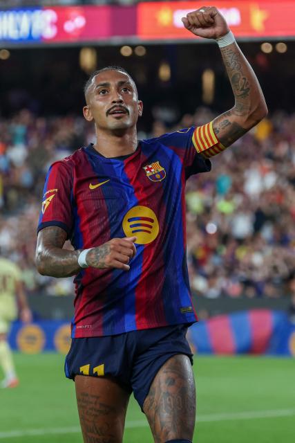 Barcelona's Brazilian forward #11 Raphinha celebrates after scoring their second goal from the penalty spot during the 61st Joan Gamper Trophy football match between FC Barcelona and Al Ahly FC at the Camp Nou Stadium in Barcelona on August 19, 2026. (Photo by Lluis GENE / AFP)
