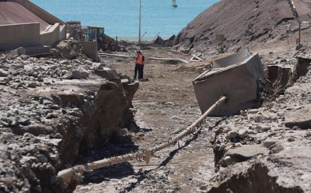 This image shows damages at the Coloso fishermen's cove, affected by a mudslide following heavy rainfall in Antofagasta, northern Chile, on August 19, 2026. (Photo by SEBASTIAN ROJAS ROJO / AFP)