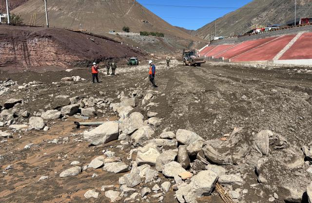 This image shows damages at the Coloso fishermen's cove, affected by a mudslide following heavy rainfall in Antofagasta, northern Chile, on August 19, 2026. (Photo by SEBASTIAN ROJAS ROJO / AFP)