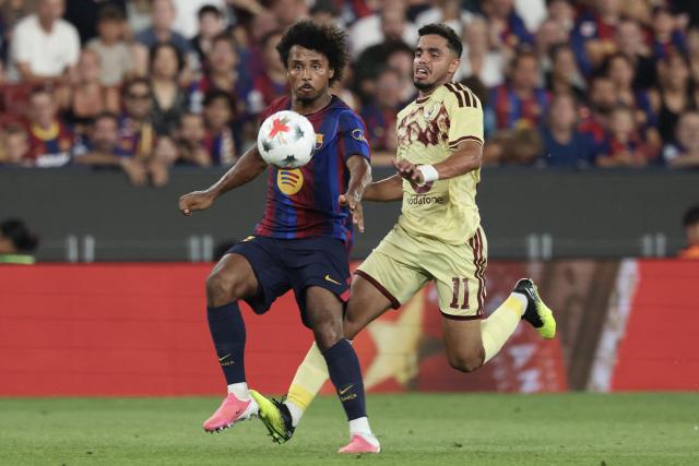 Barcelona's German forward Karim Adeyemi (L) vies for the ball with Al Ahly's Egyptian defender Karim El Debes (R) during the 61st Joan Gamper Trophy football match between FC Barcelona and Al Ahly FC at the Camp Nou Stadium in Barcelona on August 19, 2026. (Photo by Lluis GENE / AFP)