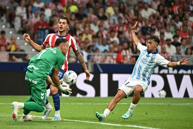 Atletico Madrid's Spanish forward #12 Carlos Martin fails to score past Malaga's Spanish goalkeeper #01 Alfonso Herrero (L)  during the Spanish league football match between Club Atletico de Madrid and Malaga CF at the Metropolitano Stadium in Madrid on August 19, 2026. (Photo by Javier SORIANO / AFP)