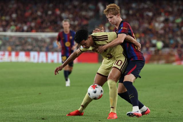 Barcelona's Spanish defender #33 Jordi Pesquer (R) vies for the ball with Al Ahly's Algerian forward Mounsef Bakrar during the 61st Joan Gamper Trophy football match between FC Barcelona and Al Ahly FC at the Camp Nou Stadium in Barcelona on August 19, 2026. (Photo by Lluis GENE / AFP)