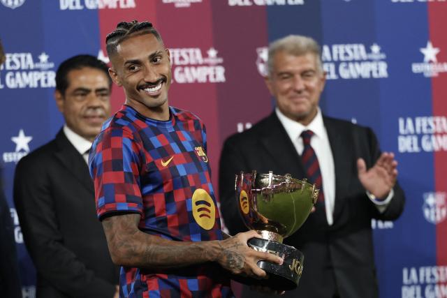 Barcelona's Brazilian forward #11 Raphinha holds the trophy after Barcelona won the 61st Joan Gamper Trophy football match between FC Barcelona and Al Ahly FC at the Camp Nou Stadium in Barcelona on August 19, 2026. (Photo by Lluis GENE / AFP)