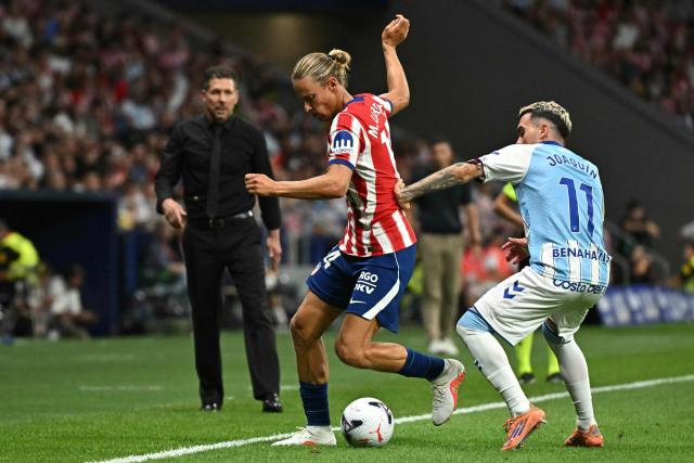Atletico Madrid's Spanish midfielder #14 Marcos Llorente vies for the ball with Malaga's Spanish forward #11 Joaquin Munoz Benavides during the Spanish league football match between Club Atletico de Madrid and Malaga CF at the Metropolitano Stadium in Madrid on August 19, 2026. (Photo by Javier SORIANO / AFP)