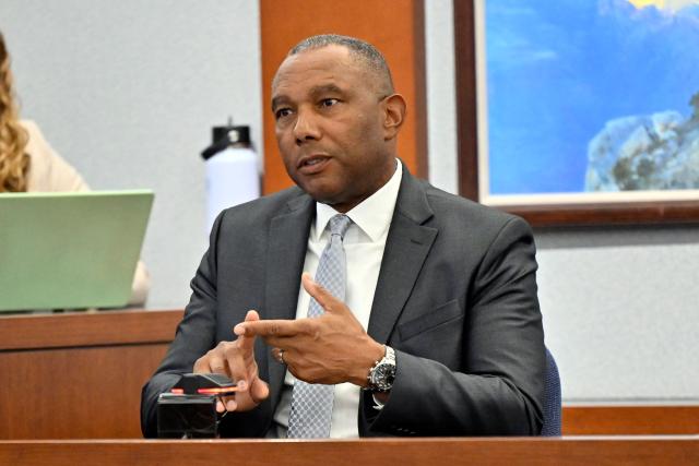 Former FBI special agent Wade Lee testifies during the Duane Davis murder trial, related to the 1996 killing of rapper Tupac Shakur, at Clark County District Court at the Regional Justice Center in Las Vegas, Nevada, on August 19, 2026. The trial of the former gang leader accused of orchestrating the murder of rapper Tupac Shakur began on August 10, 30 years after one of America's most high-profile unresolved killings. The proceedings, expected to last a month, will likely not make clear who fired the shots that killed the California hip-hop legend on the night of September 7, 1996, while he was in Las Vegas to see a Mike Tyson boxing match. (Photo by David Becker / POOL / AFP)