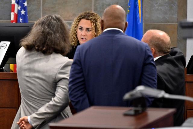 District Court Judge Carli Kierny (2nd L) speaks with Duane Davis' attorney Michael Sanft (L) and Chief Deputy District Attorneys Binu Palal (2nd R) and Marc DiGiacomo during the Duane Davis murder trial, related to the 1996 killing of rapper Tupac Shakur, at Clark County District Court at the Regional Justice Center in Las Vegas, Nevada, on August 19, 2026. The trial of the former gang leader accused of orchestrating the murder of rapper Tupac Shakur began on August 10, 30 years after one of America's most high-profile unresolved killings. The proceedings, expected to last a month, will likely not make clear who fired the shots that killed the California hip-hop legend on the night of September 7, 1996, while he was in Las Vegas to see a Mike Tyson boxing match. (Photo by David Becker / POOL / AFP)
